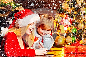 Mom and kid play together christmas eve. Happy family. Family holiday. Santa claus coming. Mother and little child boy