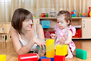 Mom and kid play toys indoors