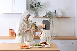 Mom and Kids Preparing ketupat Lebaran for Eid Al Fitr Celebration photo