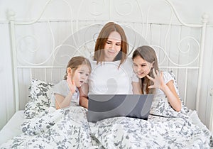 Mom with kids talk relatives via video connection