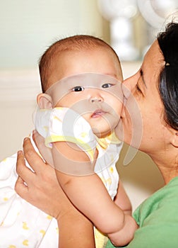 Mom kissing baby