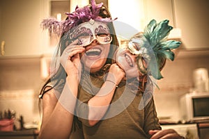 Mom lets hide with mask. Little girl have play with mother.