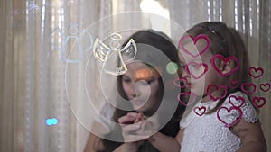 Mom with little daughter draw heart and angel paints on glass.
