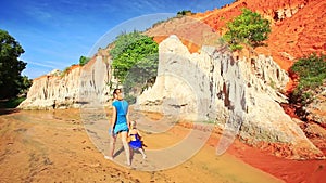 Mom Little Daughter Walk in Water to High Long Cliff