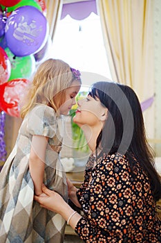 mom and little girl gently hug. maternal love and care.