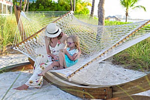 Mom and little girl relaxing in hammock at