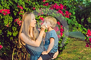 Mom looks at his son who is allergic to pollen