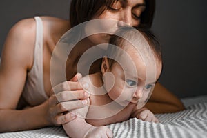 Mom, mummy, young mother with little baby daughter. Breast-feeding. Mum kissing,hugging child. Newborn cute happy girl