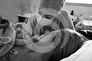 Mom and newborn baby skin to the skin after birth in the hospital