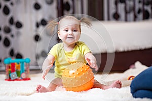 Mom playing ball with baby girl indoor