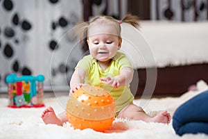 Mom playing ball with baby indoor