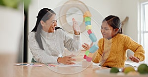 Mom playing with building blocks with her daughter in the kitchen for child development at home. Happy, bonding and