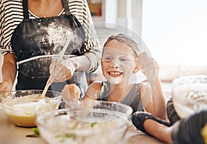 Mom, playing or happy girl baking in kitchen as a happy family with a playful young kid with flour at home. Dirty, messy