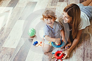 Mom playing with son on a floor