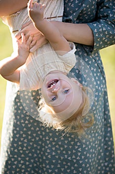 Mom playing with tot daughter