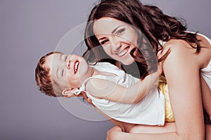 Mom playing with young son laughing joy