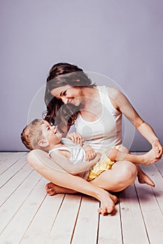 Mom playing with young son laughing joy