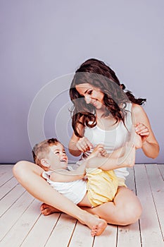 Mom playing with young son laughing joy