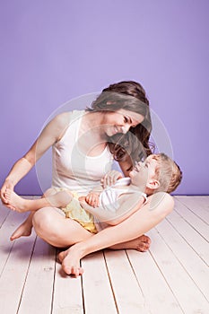 Mom playing with young son laughing joy