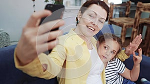 mom plays with her daughter at home a take a selfie. happy family kid dream stay home concept. mom plays with daughter