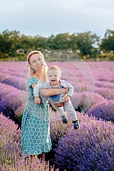 Mom plays with her son in a lavender field