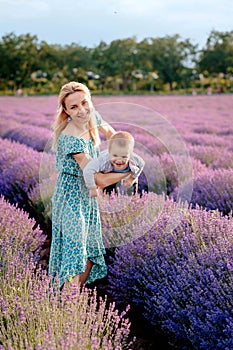 Mom plays with her son in a lavender field