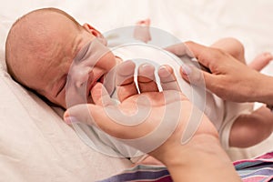 Mom prepare her newborn baby to breastfeed