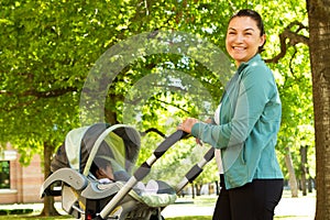 Mom pushing her baby in a stroller.