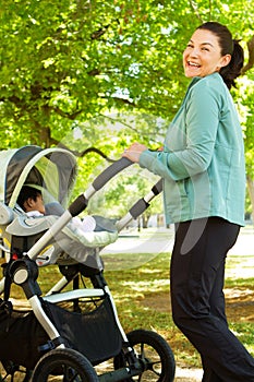 Mom pushing her baby in a stroller.