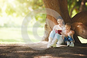 Mom reading a book to her child