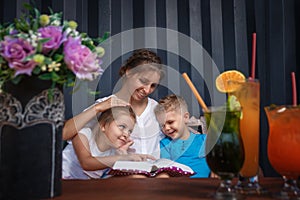 Mom is reading a book to her children.