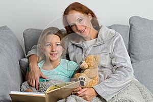 Mom reading book to her daughter