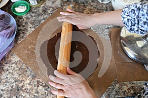 Mom rolls dough. chocolate dough. Hands working with dough preparation recipe bread. Female hands making dough for pizza. Woman`s