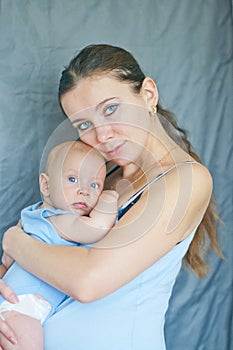 Mom`s love and tenderness. Mother and baby. Happy family. blue-eyed mother holds a child.