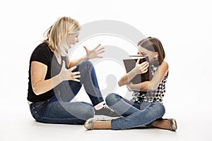 Mom scolds the daughter of a teenager. The conflict of generations. White background