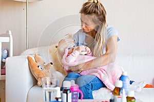 Mom with sick baby at home