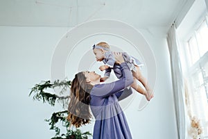 Mom smiles and kisses her daughter. A happy family. Portrait of a mother.