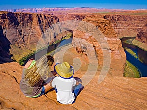 Mom and son admire panorama of Horseshoe Bend, Page Arizona, The Colorado River