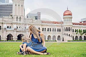 Mom and son on background of Merdeka square and Sultan Abdul Sam