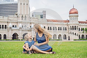 Mom and son on background of Merdeka square and Sultan Abdul Sam