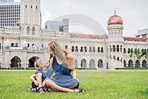 Mom and son on background of Merdeka square and Sultan Abdul Samad Building. Traveling with children concept