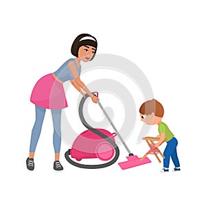 Mom and son cleaning room together, woman with vacuum cleaner