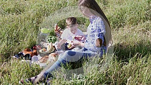 Mom son eat at a picnic in the forest 1