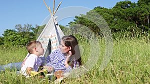 Mom son eat at a picnic in the forest