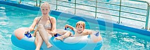 Mom and son have fun at the water park BANNER, long format