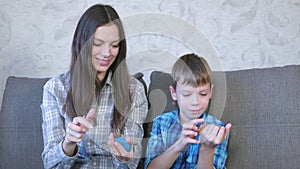 Mom and son inflate a big bubbles from a slimes. Play with slime.