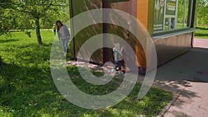 Mom and son play hide and seek in park