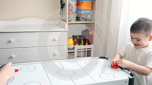 Mom and son play with passion in air hockey