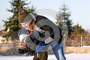 Mom and son playing in snow