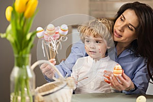 Mom and son prepare Easter decorations.